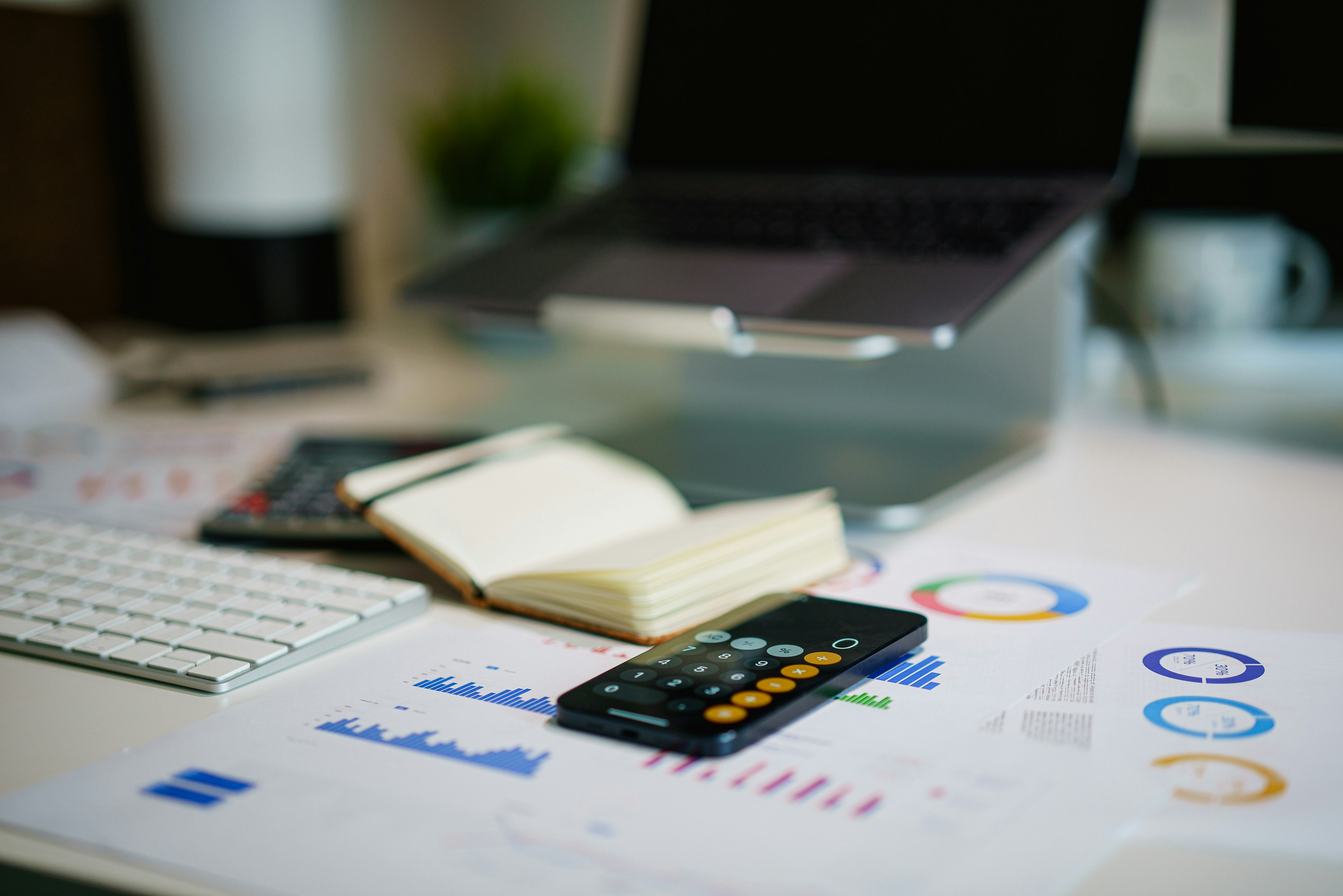 Image of a laptop with notebook and calculator