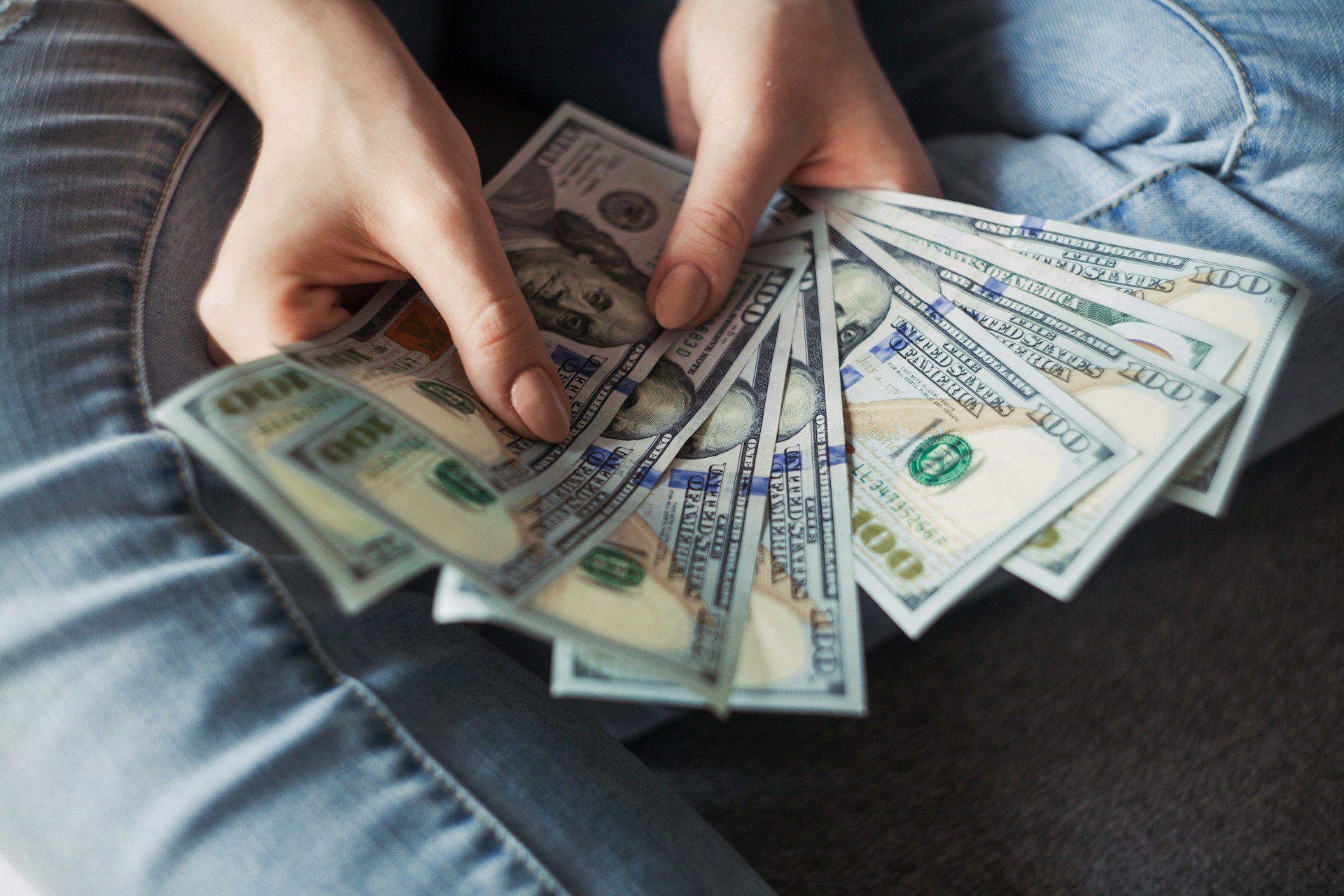 Money spread out on a table representing the financial impact of car payments on retirement savings