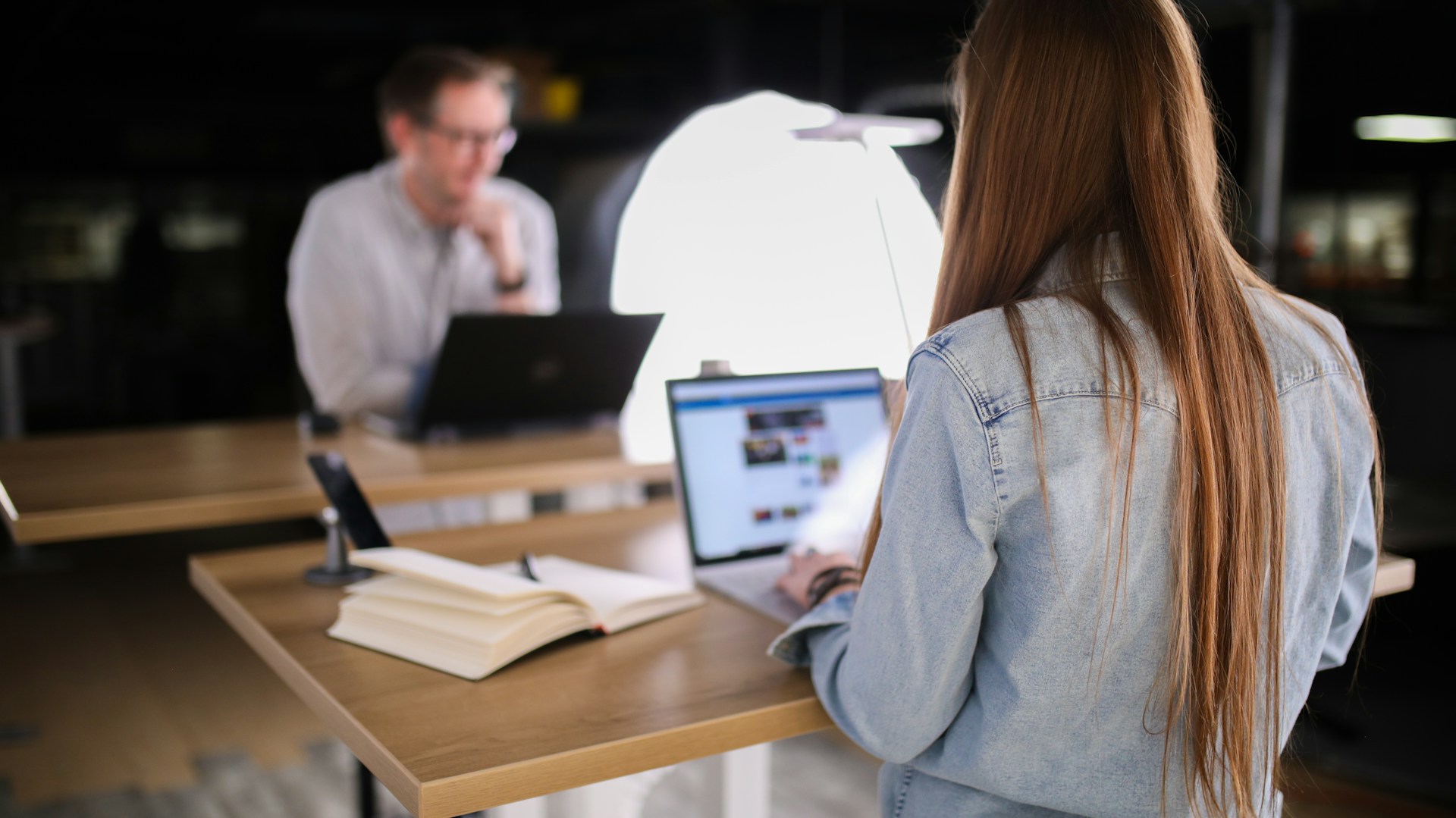 Remote worker at a standing desk representing geographic arbitrage and location independence